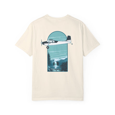 Aviation beige t-shirt featuring a graphic print of an Cessna 180 airplane flying over a waterfall