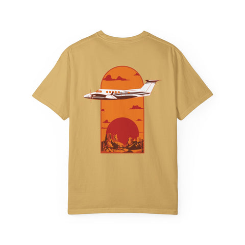 Aviation orange tee with a graphic design of a King Air plane flying over a canyon landscape background